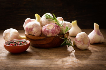 Fresh garlic bulbs with rosemary and pepper