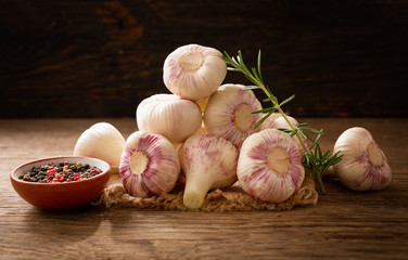 Fresh garlic bulbs with rosemary and pepper