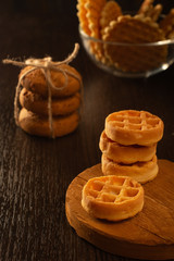 Waffle round-shaped biscuits on the table, white plate