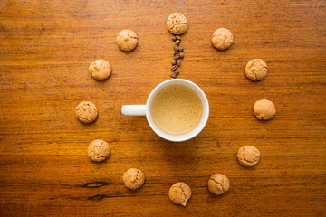 cup of coffee and amaretti on a clock 