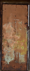 Old yellow metal door. Vintage texture with peeling paint