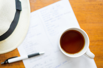 cup of coffee and paper on a wood table
