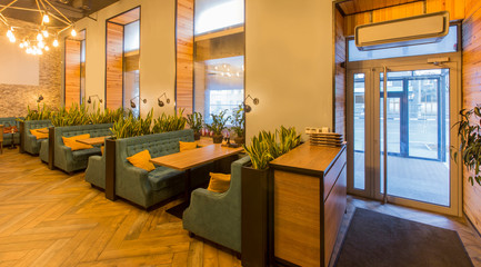 Restaurant interior with cozy atmosphere, stylish dining places