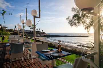 Fototapeta premium empty beach restaurant at sunrise, resort vacation concept