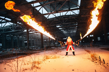 Santa Claus with flamethrowers in an abandoned warehouse