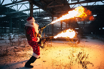 Santa Claus with flamethrowers in an abandoned warehouse