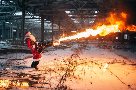 Santa Claus with flamethrowers in an abandoned warehouse