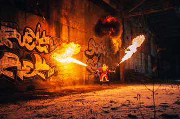Santa Claus with flamethrowers in an abandoned warehouse