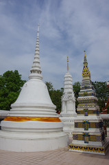 Beautifully decorated stupas at Wat Intharawihan temple, Bangkok, Thailand. Traditional religious architecture, one of the main attractions on Bangkok.