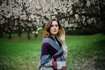 Obraz premium Beautiful young girl is resting and enjoying spring in the spring park