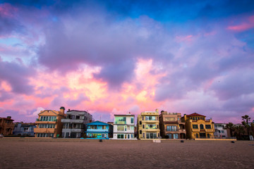 Dramatic storm clouds hover over the colorful beach cityscape of Hermosa Beach, California just after sunset.