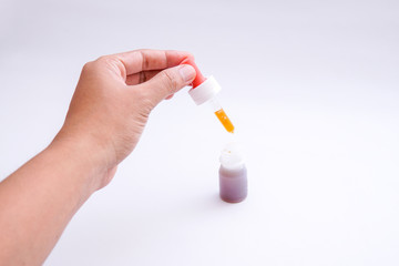 dripping the vaccine using a medical pipette isolated white background