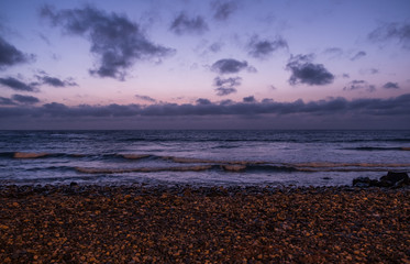 Waves on the Atlantic Ocean at sunrise. Caleta de La Guirra Beach, Fuerteventura, Canary islands, Spain. October 2019