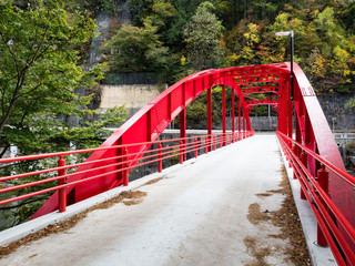 Red bridge over the Kiso river at Kiso-no-Kakehashi, a scenic spot in Kiso valley - Nagano prefecture, Japan