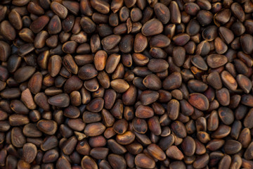 Brown inshell pine nuts. Top view. Texture