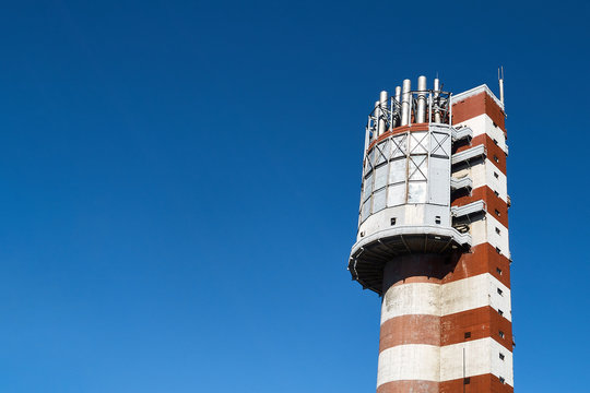 Tower granulator technology for production of new urea based compound fertilizer with smooth particles better strength granularity. Chemical plant over blue sky background with copyspace.