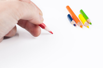 Colour pencils in hand isolated on white background.Copy space