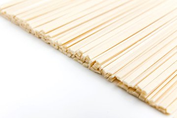 Raw udon noodles on white, horizontal photo