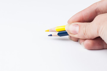 Colour pencils in hand isolated on white background.Copy space