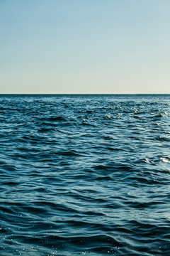 image of calm blue sea at sunset