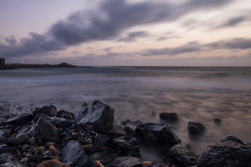 Fototapeta premium Waves on the Atlantic Ocean at sunrise. Caleta de La Guirra Beach, Fuerteventura, Canary islands, Spain. October 2019. Long exposure shot.
