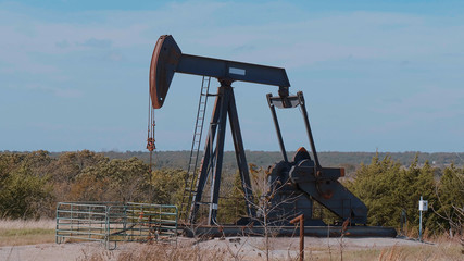 Oil pump in the countryside of Oklahoma - Pump jack - USA 2017