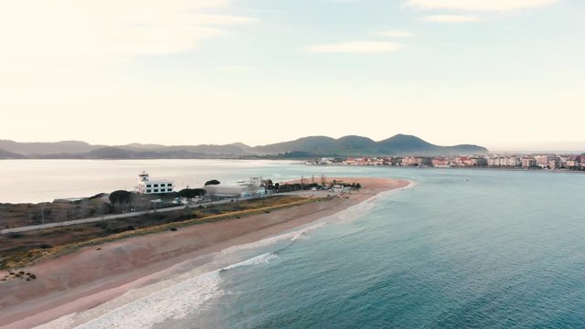 Aerial drone view of a beach bay sunset with dunes in Puntal, Laredo. Ideal for surfing.