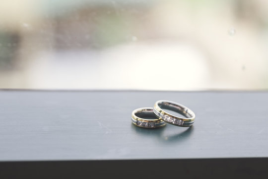Close-up Of Wedding Rings On Table