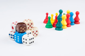 Colorful play figures with dice isolated on white background.Copy space