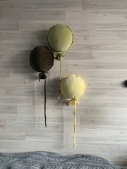 green and olive pillow balls hanging on the wall in the interior
