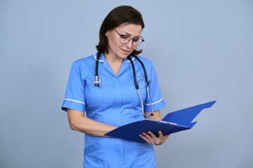 Portrait of mature nurse woman holding clipboard