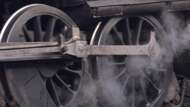 Steam train close up of wheels moving on track UK 4K