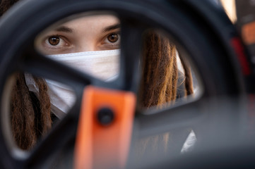 girl with dreadlocks in a protective mask on her face