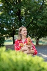 portrait of smiling teenager girl with package of bread products in hands