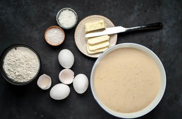 The recipe for making homemade pancakes from
flour, eggs, butter, milk, salt, sugar on a stone background
