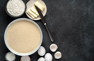 The recipe for making homemade pancakes from
flour, eggs, butter, milk, salt, sugar on a stone background