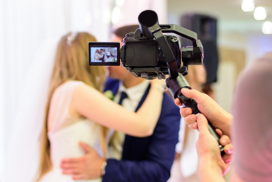 Cameraman recording video of a wedding
