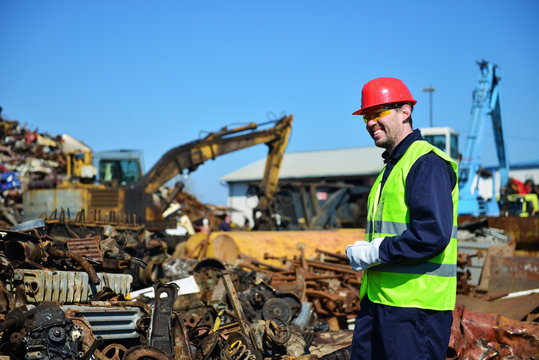 Worker on junkyard. Copy space available.