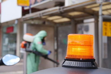 A person disinfects a bus stop from the Corona virus.
