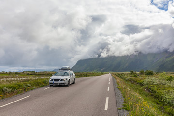 Lofoten, Norway - June 20, 2017: A gray car parked on the shore of a Norwegian fjord