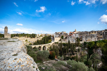 Fototapeta na wymiar suggestive view of the Gravina and the rock churches (Gravina with the meaning of rock, shaft and erosion of bank river). Gravina in Puglia ancient town, bridge and canyon. Apulia, Italy, Europe
