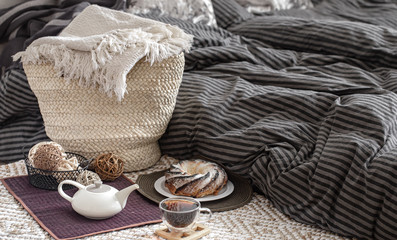 A teapot and a Cup of tea on the table in a cozy home interior.
