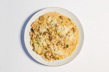 Risotto with mushrooms and cheese served on a restaurant table