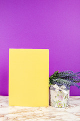 Blank notebook with lavender flowers and floral box on a purple background