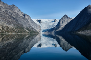 Fototapeta na wymiar Glacier and mountain reflection in the fjord