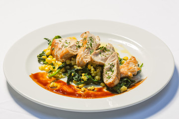 Grilled chicken breasts with cooked vegetables corn and chard