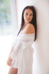 Fototapeta premium beautiful woman near the glass door in the early morning