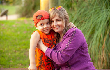 portrait of happy mother with her son outdoors