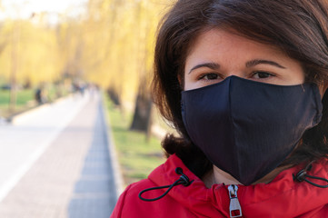 Portrait of a woman with hand made black mask. Quarantine in 2020.