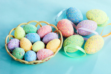 Multi-colored Easter eggs in a basket. Spring decor.